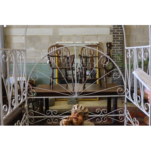 1138 - A painted wrought iron rose arbour garden seat, width 120cm, depth 62cm, height 218cm