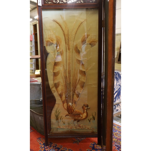 1139 - An Edwardian silk thread embroidered two fold dressing screen worked with a peacock and a stag, each... 