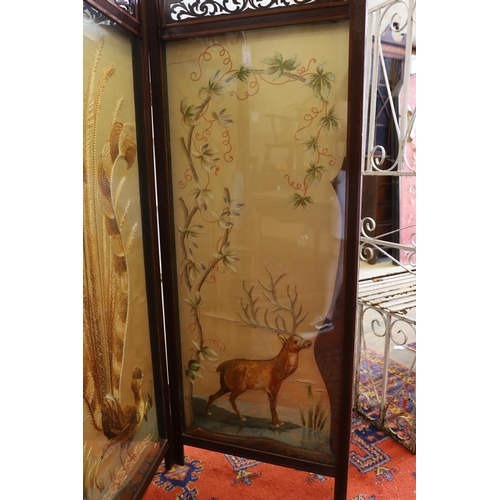 1139 - An Edwardian silk thread embroidered two fold dressing screen worked with a peacock and a stag, each... 