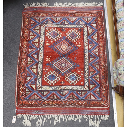 1163 - A Turkish red ground rug, 134 x 99cm