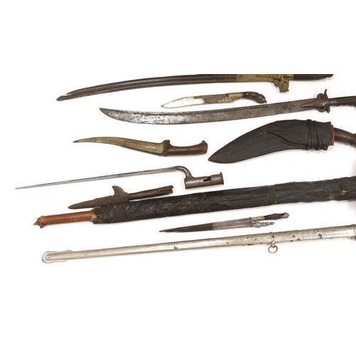 1253 - Two Sinhalese daggers and a kukri, a silver inlaid Kirichchiya dagger, together with another in a sc... 