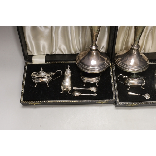 1848 - Two modern cased silver three piece cruet sets, with spoons and a pair of modern silver candlesticks... 