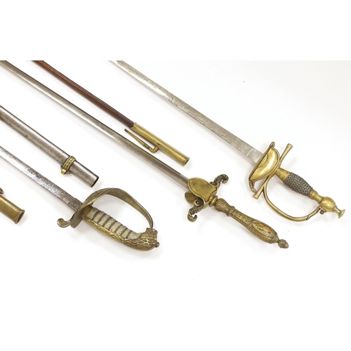 1256 - Three 20th century short swords; a court sword in a leather scabbard, a naval style sword, plus anot... 