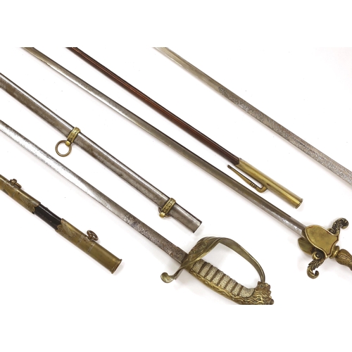 1256 - Three 20th century short swords; a court sword in a leather scabbard, a naval style sword, plus anot... 