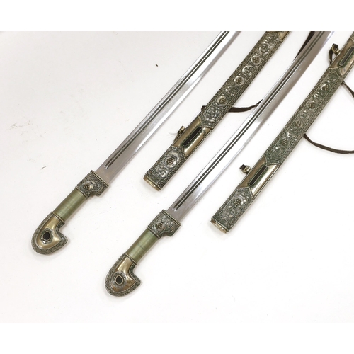 1258 - A pair of reproduction Turkish swords with white metal filigree scabbards, blades 80cm