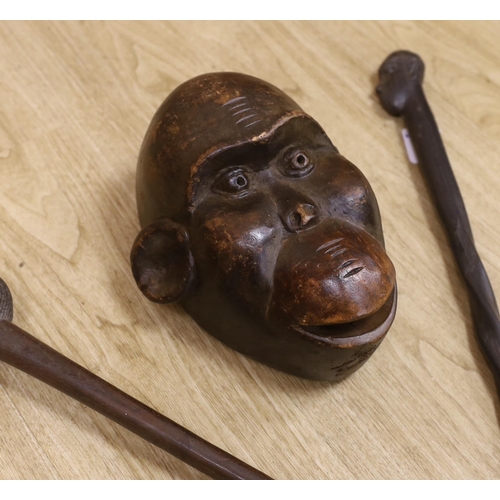 1309 - A tribal mask, a Knobkerrie and stick with carved head, stick 62.5cm