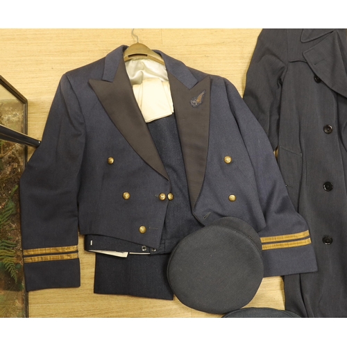 1316 - A collection of post-war RAF uniforms, comprising; two caps, double-breasted overcoat, dress uniform... 