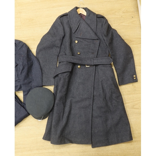 1317 - A 1960s RAF uniform comprising; great coat, blouse, cap and trousers, all with manufacturers labels... 