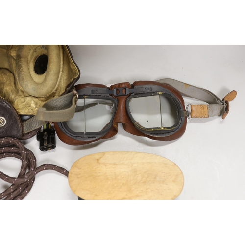 1321 - A WWII RAF flying helmet with speaker earpieces and original cables and plugs, Ref No.10A/13466, ini... 