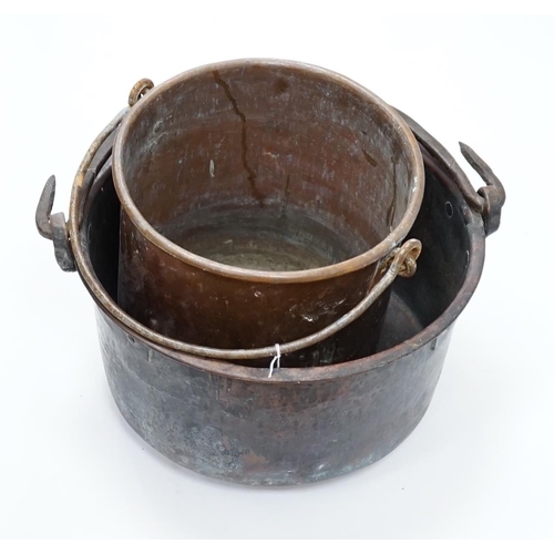 1334 - Two copper cauldrons with swing handles, the largest 43cm wide