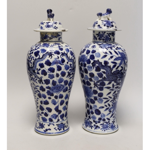 1348 - A pair of Chinese blue and white 'dragon vases and covers, Late 19th century, 29cm high