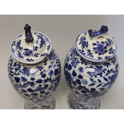 1348 - A pair of Chinese blue and white 'dragon vases and covers, Late 19th century, 29cm high