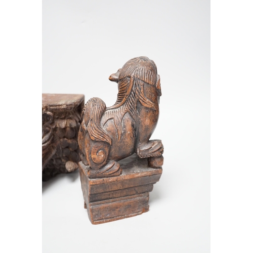 1350 - A carved South East Asian hardwood temple lion and an Indian wall bracket (2) tallest 23cm