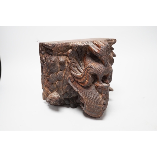 1350 - A carved South East Asian hardwood temple lion and an Indian wall bracket (2) tallest 23cm