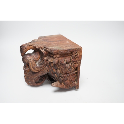 1350 - A carved South East Asian hardwood temple lion and an Indian wall bracket (2) tallest 23cm