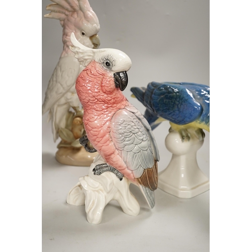 1356 - Two Royal Dux parrots and a Beswick parrot, the largest 40cm high