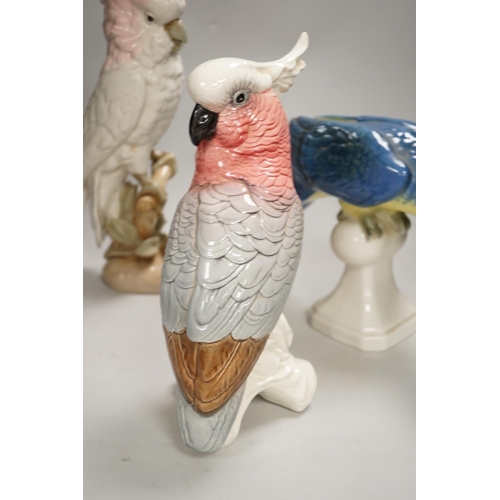 1356 - Two Royal Dux parrots and a Beswick parrot, the largest 40cm high