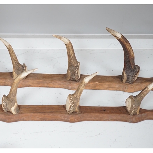 1359 - A two piece antler gun rack, 87cm high