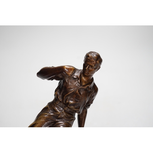 1401 - A pre-war bronze figure of a footballer, raised on a circular ebonies wood base, 23cm high