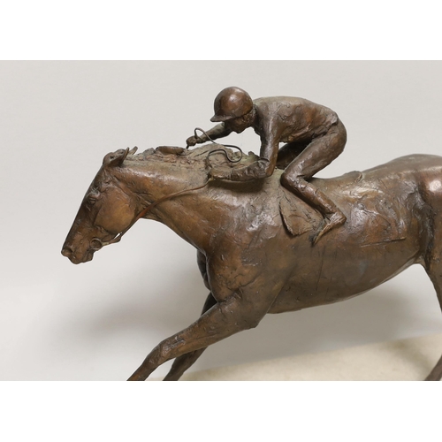 1409 - A patinated bronze of a racehorse with jockey, base 48cm long