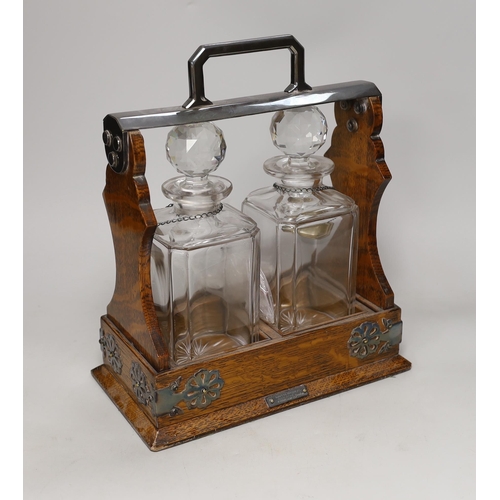 1461 - A Mappin Bros. oak and electroplate mounted two bottle tantalus, 31cm high