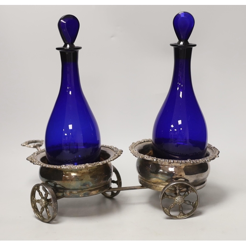 1469 - A Victorian plated twin coaster trolley and two Bristol blue decanters, trolley 43cm long