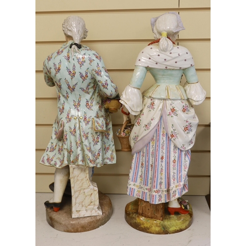 1495 - A pair of massive German porcelain figures of flower sellers, late 19th century, 66.5cm