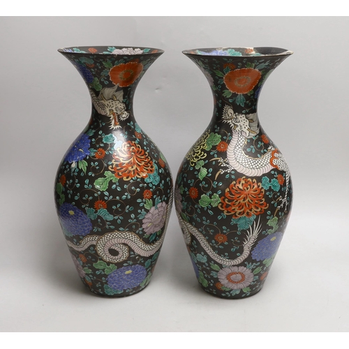 1528 - A pair of Japanese black ground dragon vases, 37cm