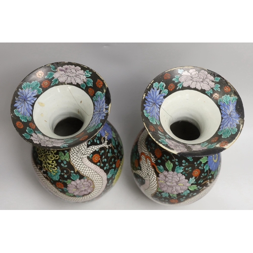 1528 - A pair of Japanese black ground dragon vases, 37cm