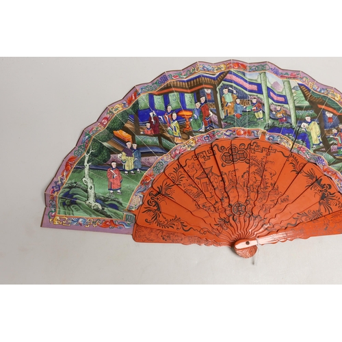 1561 - A Chinese hand painted figural fan with applied ivory faces and red lacquered guards, and boxed both... 