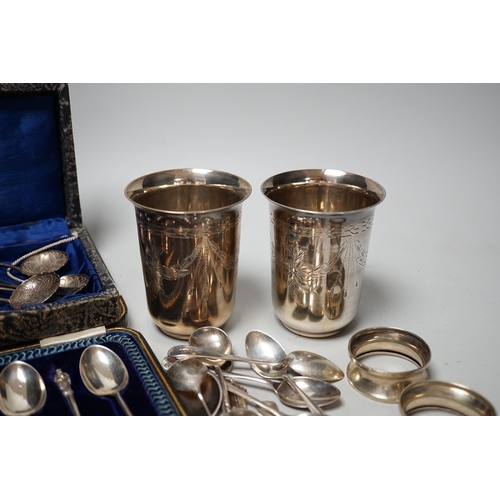 1802 - A pair of engraved white metal tumblers, stamped 'K980', four Russian 84 zolotnik spoon, a cased set... 