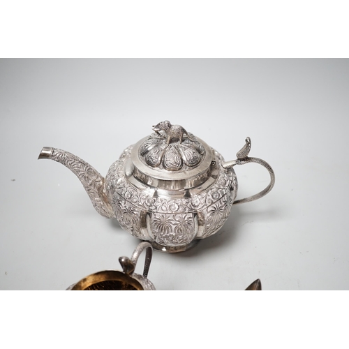 1842 - An Indian embossed white metal three piece tea set, with cobra handles and elephant finial, 25.7oz.... 