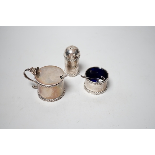 1864 - A George V three piece silver condiment set, Stokes & Ireland, Chester, 1923 and two associated spoo... 