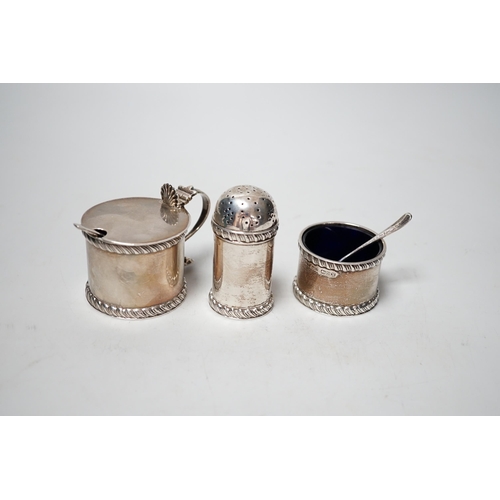 1864 - A George V three piece silver condiment set, Stokes & Ireland, Chester, 1923 and two associated spoo... 