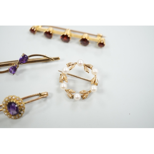 1878 - A 15ct and graduated five stone garnet set bar brooch, 48mm, a similar amethyst and seed pearl clust... 