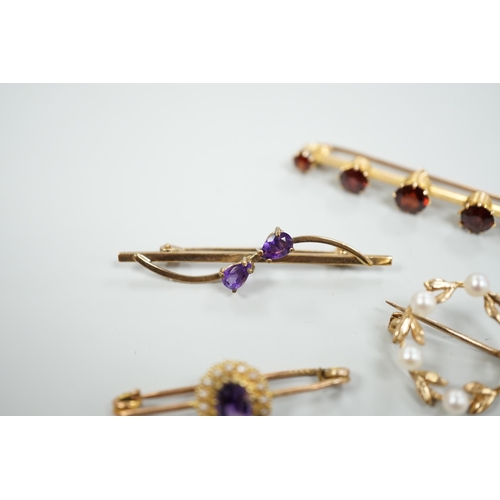 1878 - A 15ct and graduated five stone garnet set bar brooch, 48mm, a similar amethyst and seed pearl clust... 