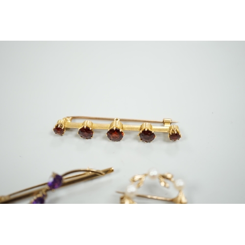 1878 - A 15ct and graduated five stone garnet set bar brooch, 48mm, a similar amethyst and seed pearl clust... 