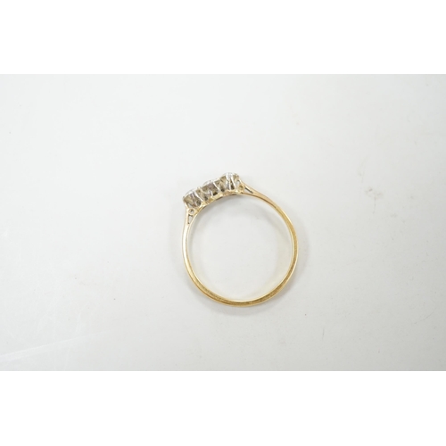 1895 - A yellow metal and three stone diamond set ring, size S/T, gross weight 2.1 grams.