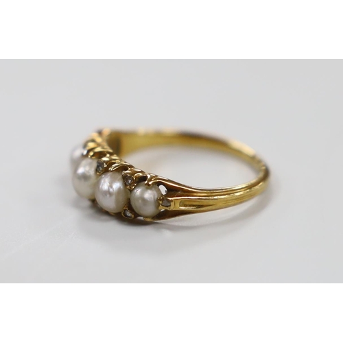 1923 - An Edwardian yellow metal and graduated split pearl set half hoop ring, with diamond chip spacers, s... 