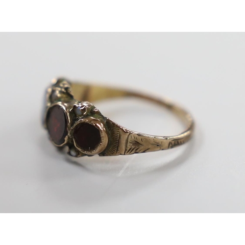 1924 - A 19th century yellow metal and graduated four stone foil backed garnet set half hoop ring, with see... 