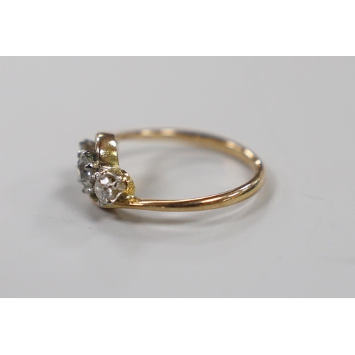 1940 - A 14k and three stone diamond set crossover ring, size H, gross weight 2 grams.