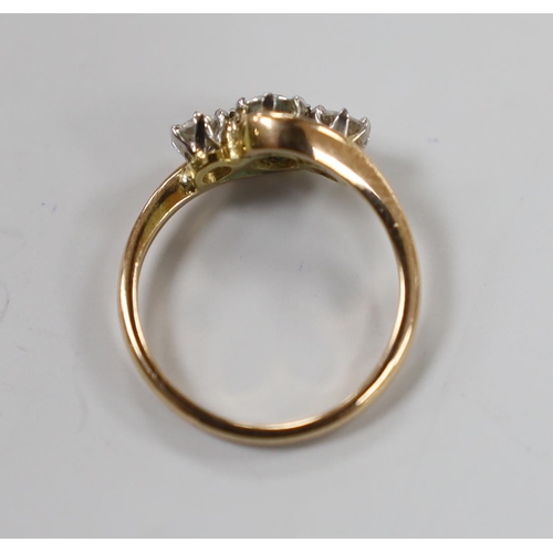 1940 - A 14k and three stone diamond set crossover ring, size H, gross weight 2 grams.