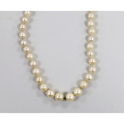 1949 - A single strand graduated cultured pearl necklace, with two stone diamond set yellow metal clasp, 37... 