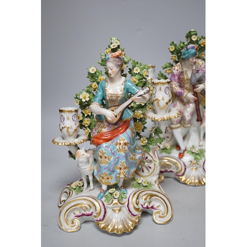 251 - A pair of French porcelain two branch figural candlesticks in the form of musicians, largest 29cm hi... 