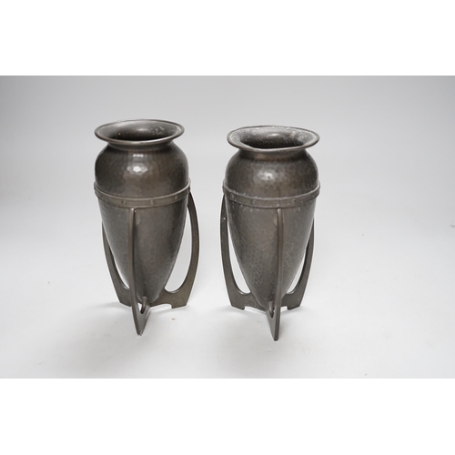 256 - After Archibald Knox, pair of Art Nouveau style hammered pewter vases, 17cm high