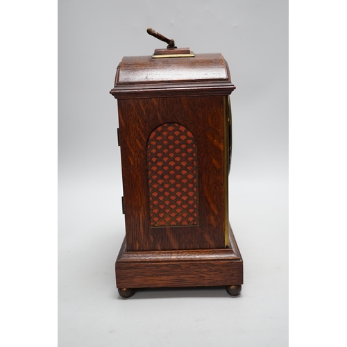 279 - A oak mantel clock in a Regency style with pad top, striking on a coiled gong, 30cm high