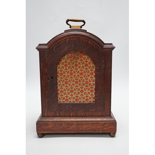 279 - A oak mantel clock in a Regency style with pad top, striking on a coiled gong, 30cm high