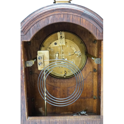 279 - A oak mantel clock in a Regency style with pad top, striking on a coiled gong, 30cm high