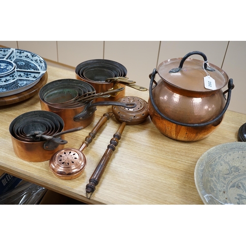 292 - A quantity of various copper-ware including graduated pans, lidded cauldron and miniature warming pa... 