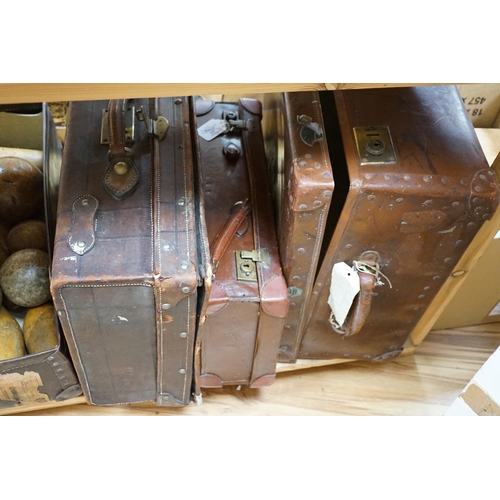 301 - Seven vintage leather suitcases and a leather writing box (locked), the largest 60cm wide